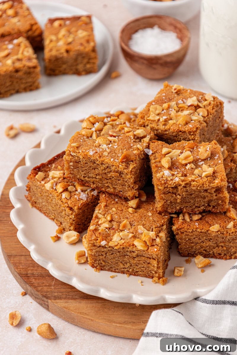 peanut butter blondies in a stacked pile on a white plate
