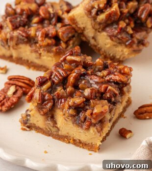 brown sugar cheesecake bar with a caramel-like pecan pie topping